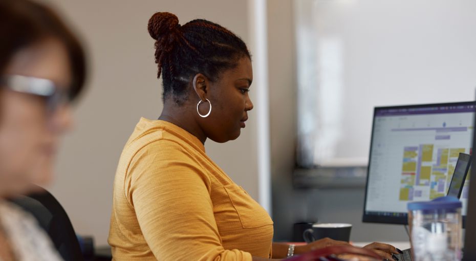 Female employee on desktop computer configuring calendars